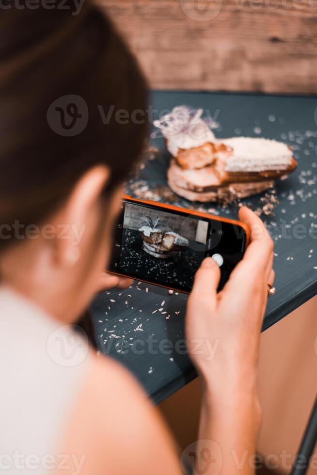 Person Capturing a Powdered Pastry on a Dark Blue Table photo