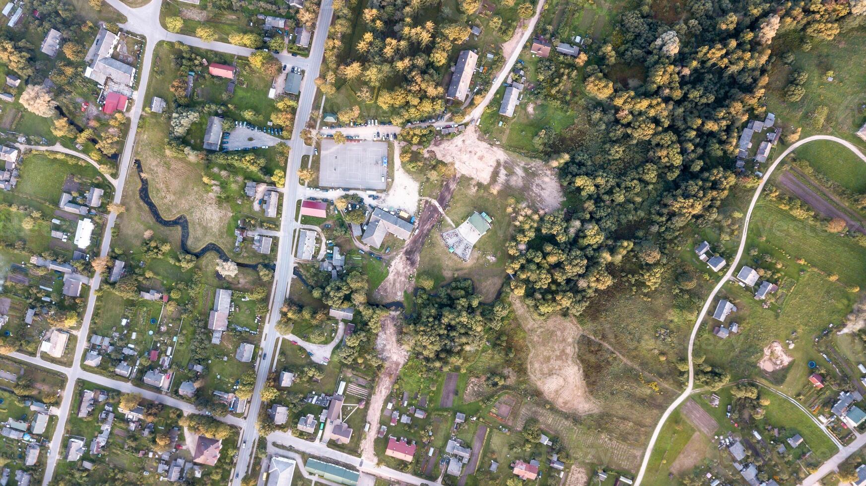 Aerial View of a Small Town with Residential Areas and Open Fields photo
