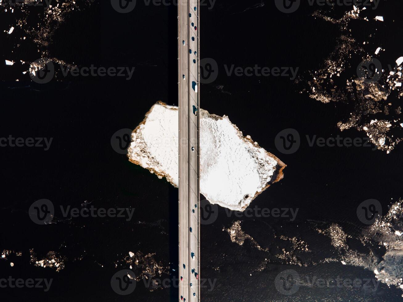 Aerial View of a Multi Lane Bridge Over Dark Water with White Landmass photo