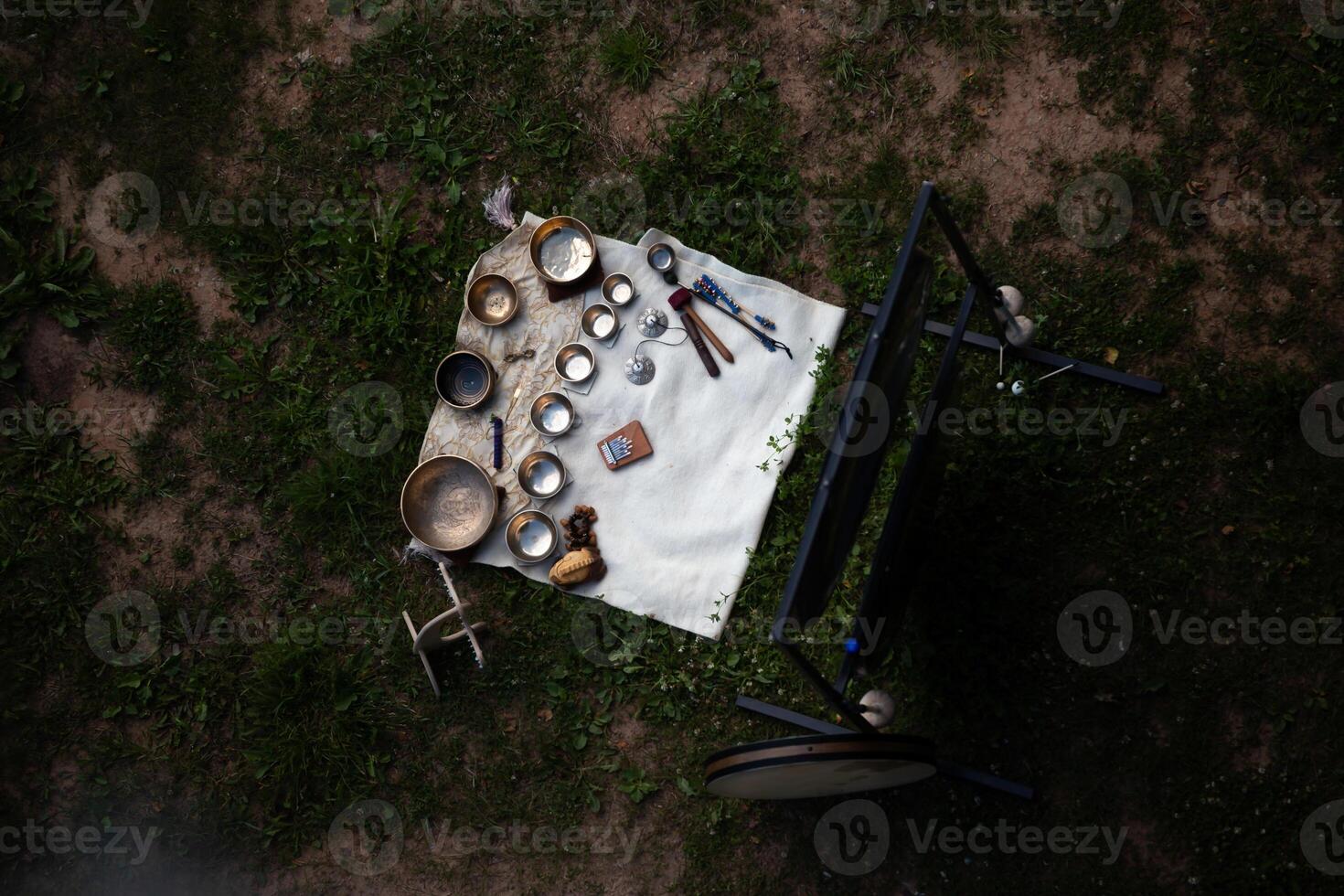 Overhead View of Ritual Items Arranged on White Cloth Outdoors photo