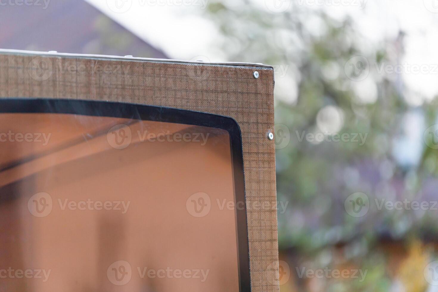 Close Up of Wooden Structure with Transparent Panel and Screws photo