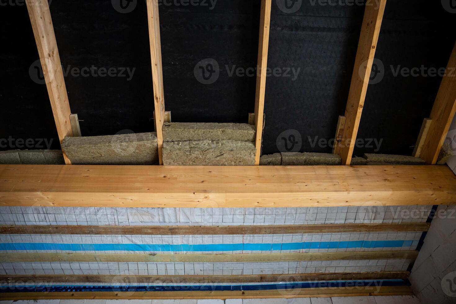 Partially Constructed Wall with Exposed Wooden Beams and Insulation photo