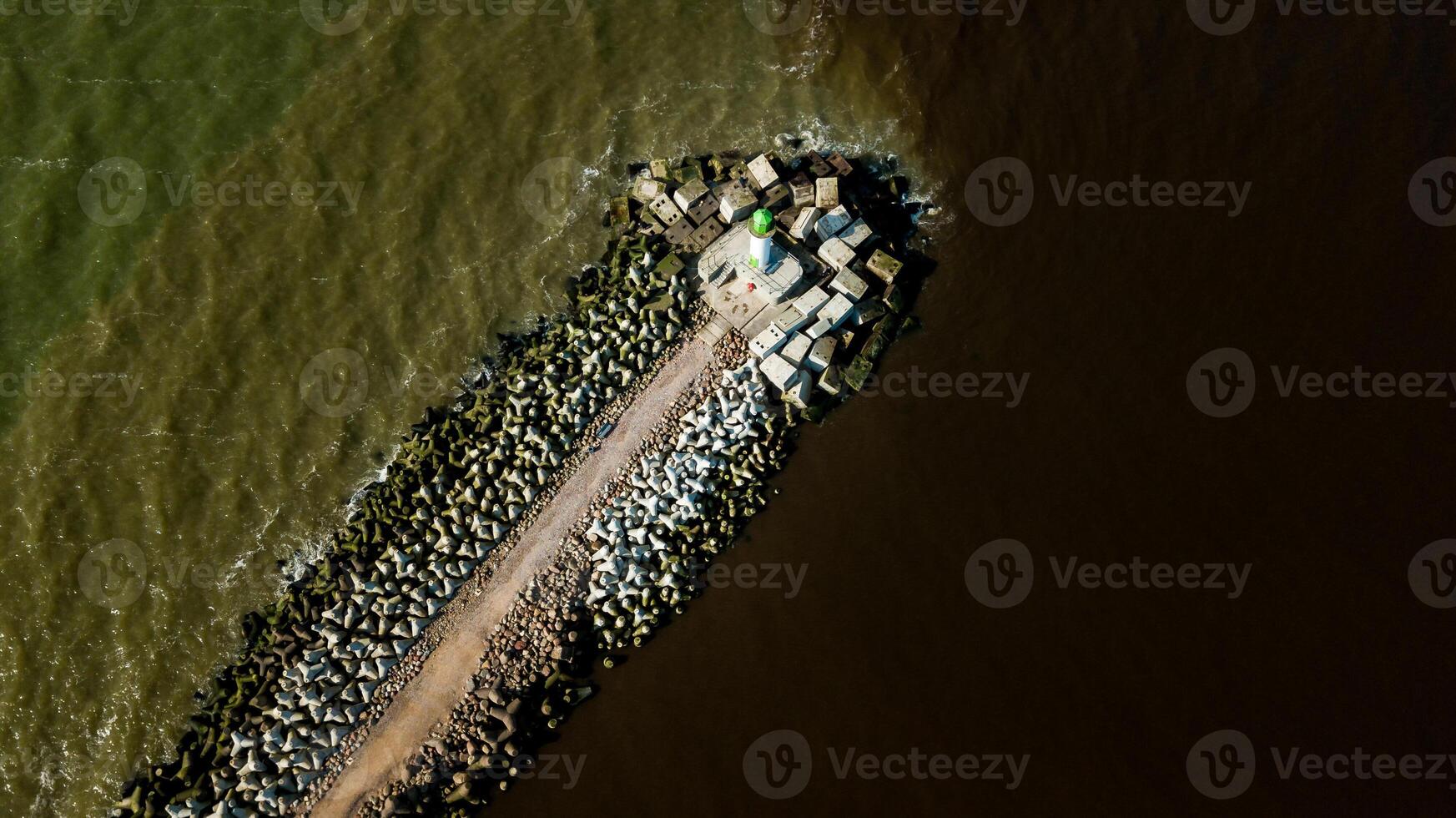 Aerial View of Breakwater with Green and White Lighthouse photo