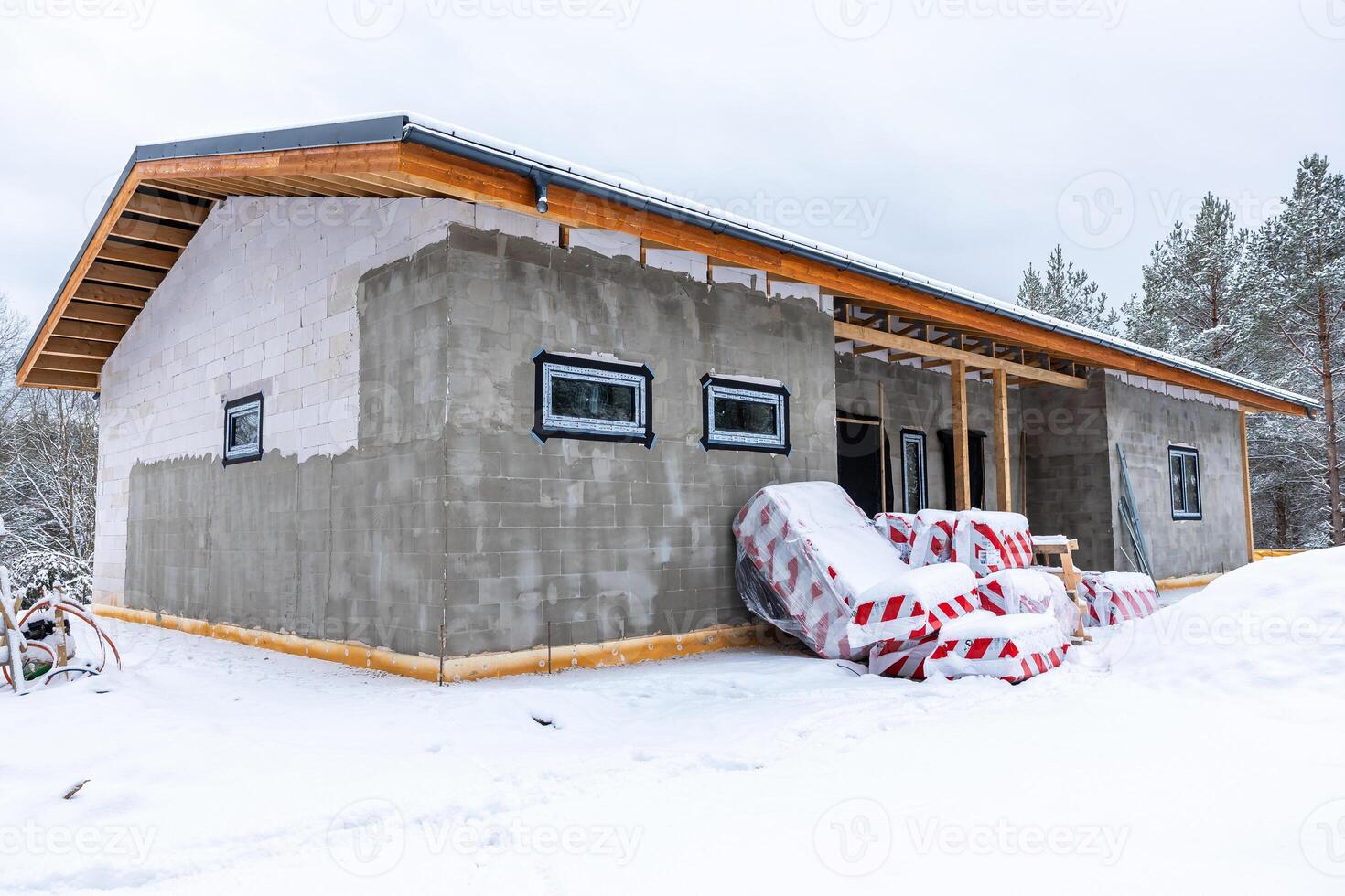 Partially Constructed Single Story Building in Snowy Forested Area photo