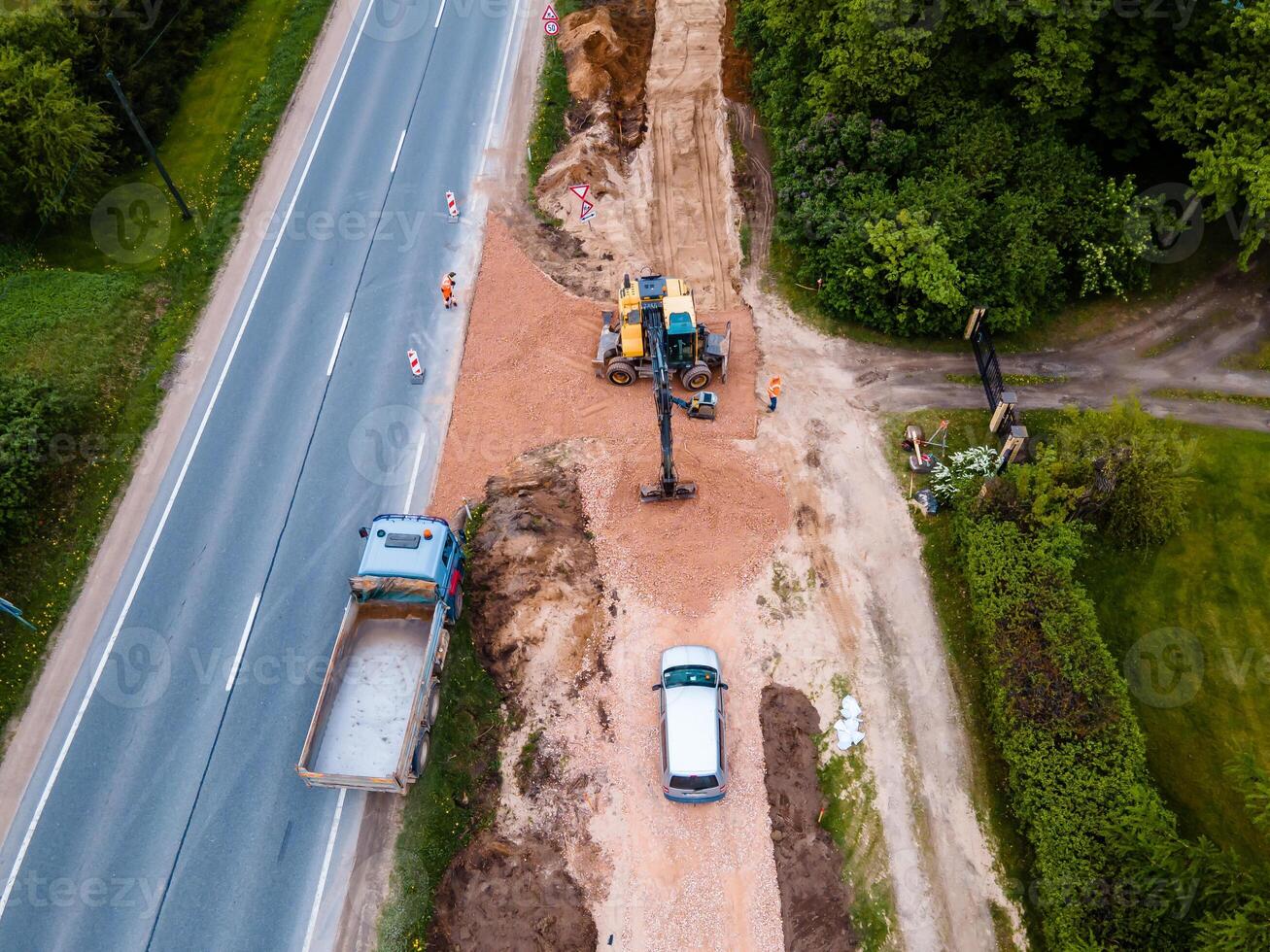 Aerial View of Road Construction Site Next to Two Lane Highway and Forest photo