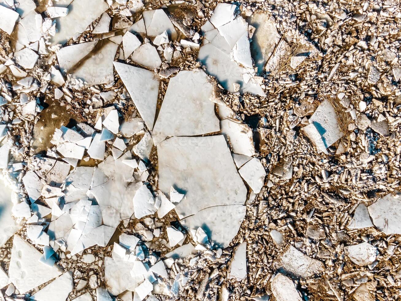 Top Down View of Cracked Ice Sheets with Gravel Fragments photo