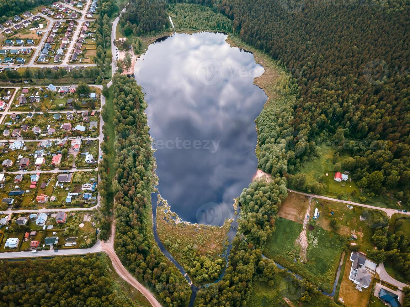 Aerial View of Reflective Lake with Forests and Residential Areas photo