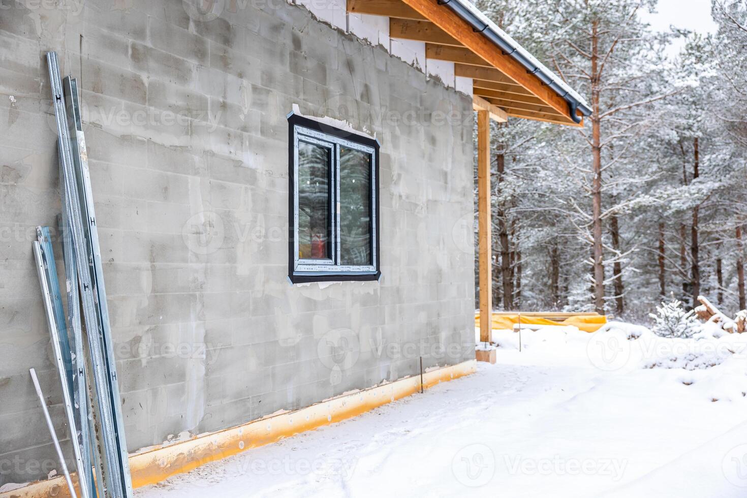 Partially Constructed Building in Snowy Forest with Pine Trees photo