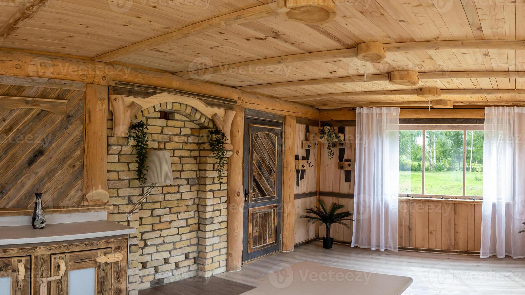 Rustic Interior with Wooden Beams, Brick Archway, and Large Window photo