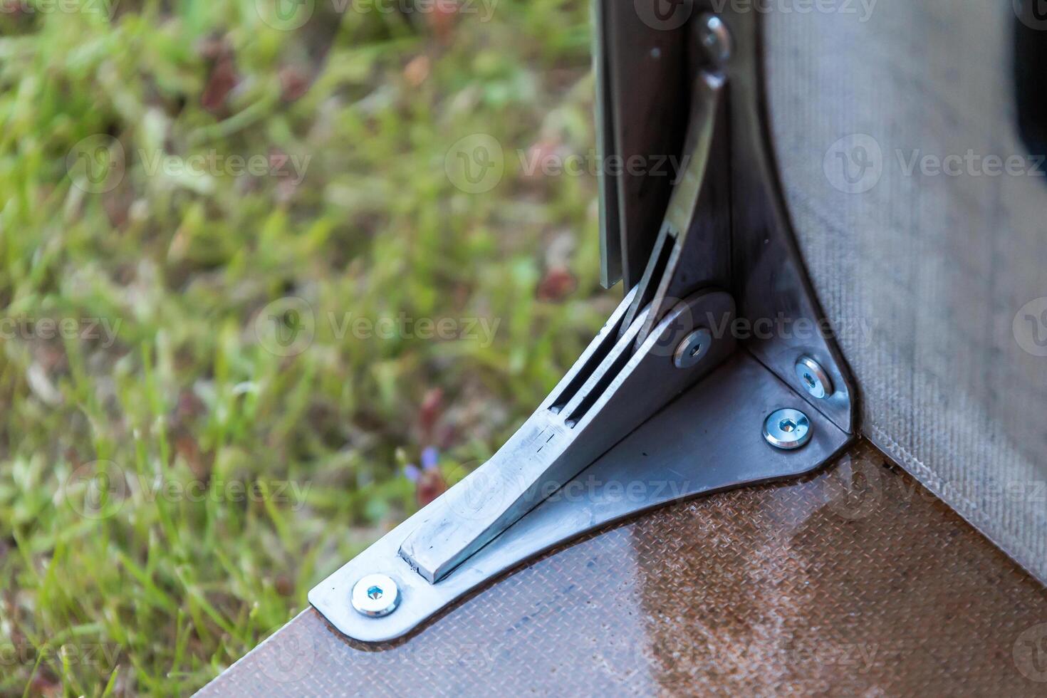 Close Up of Modern Metal Hinge on Outdoor Structure Corner photo