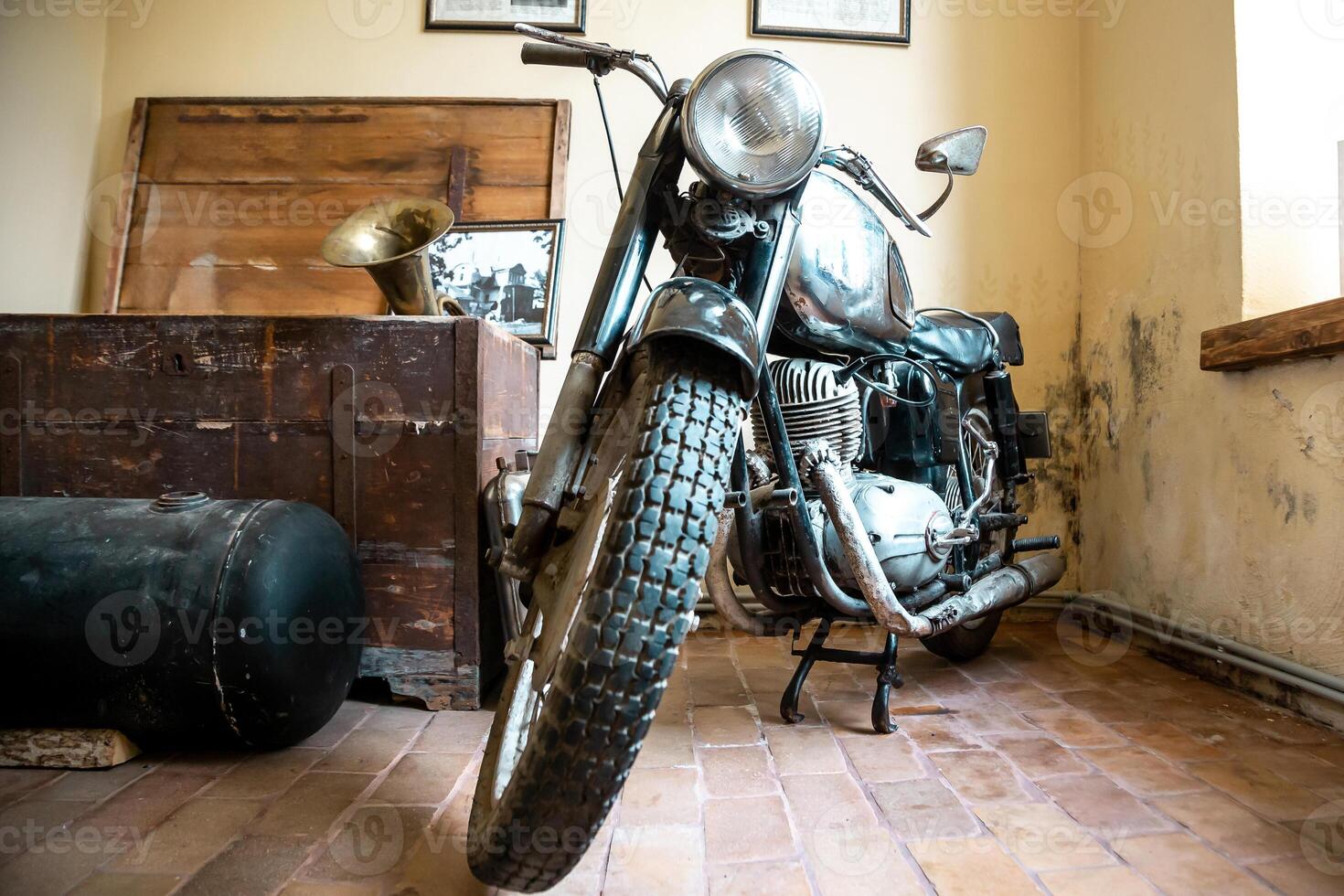 Vintage Motorcycle with Historical Artifacts in Rustic Indoor Setting photo