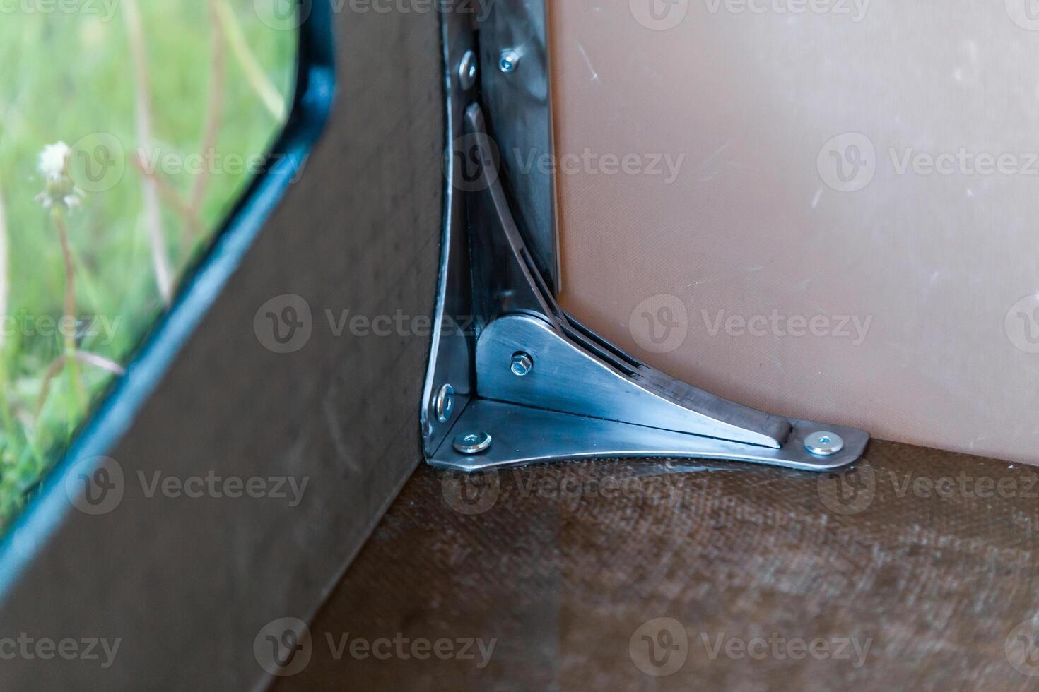 Close Up of Metal Bracket Securing Two Panels with Visible Screws photo