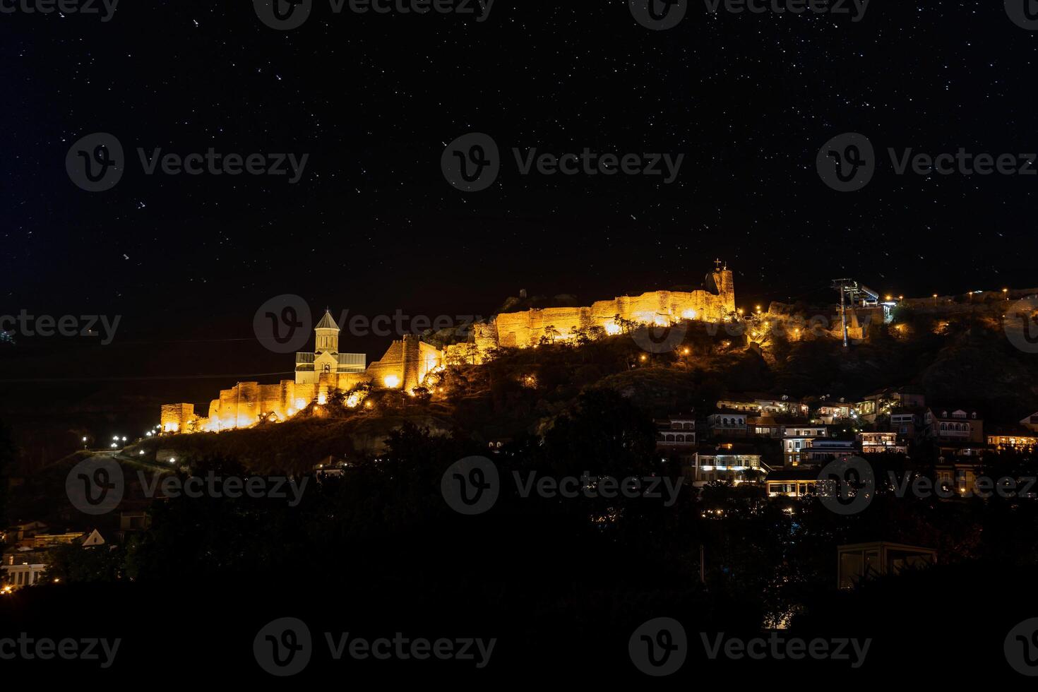 Illuminated Narikala Fortress and St. Nicholas Church at Night photo
