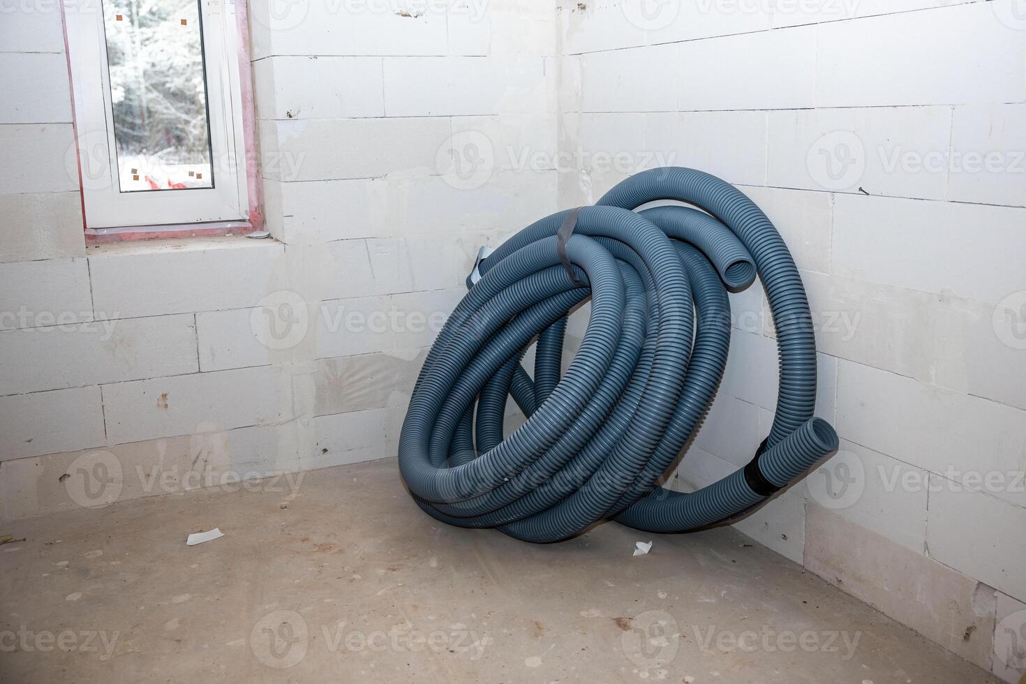 Construction Site Room with Blue Tubing and Red Framed Window photo