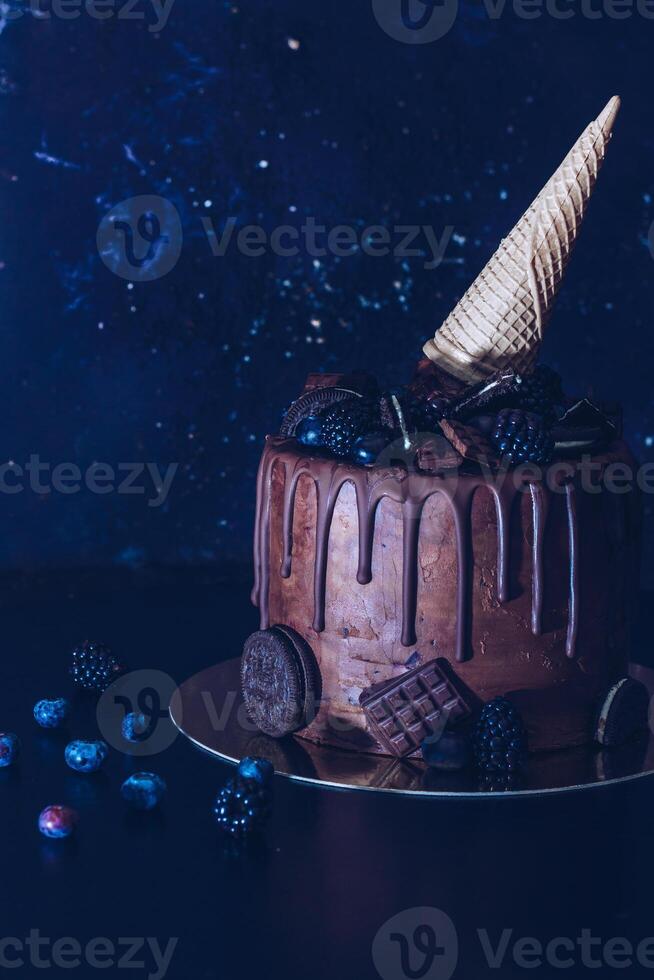 Chocolate Cake with Ice Cream Cone and Assorted Toppings photo
