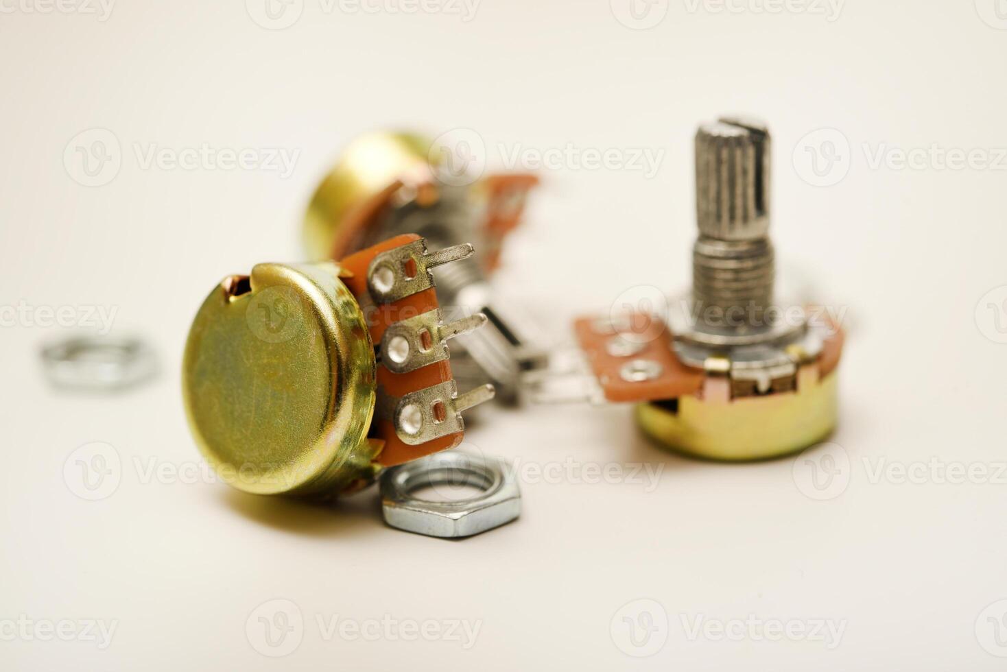 A potentiometer with fasteners. A resistor with a rotator. photo