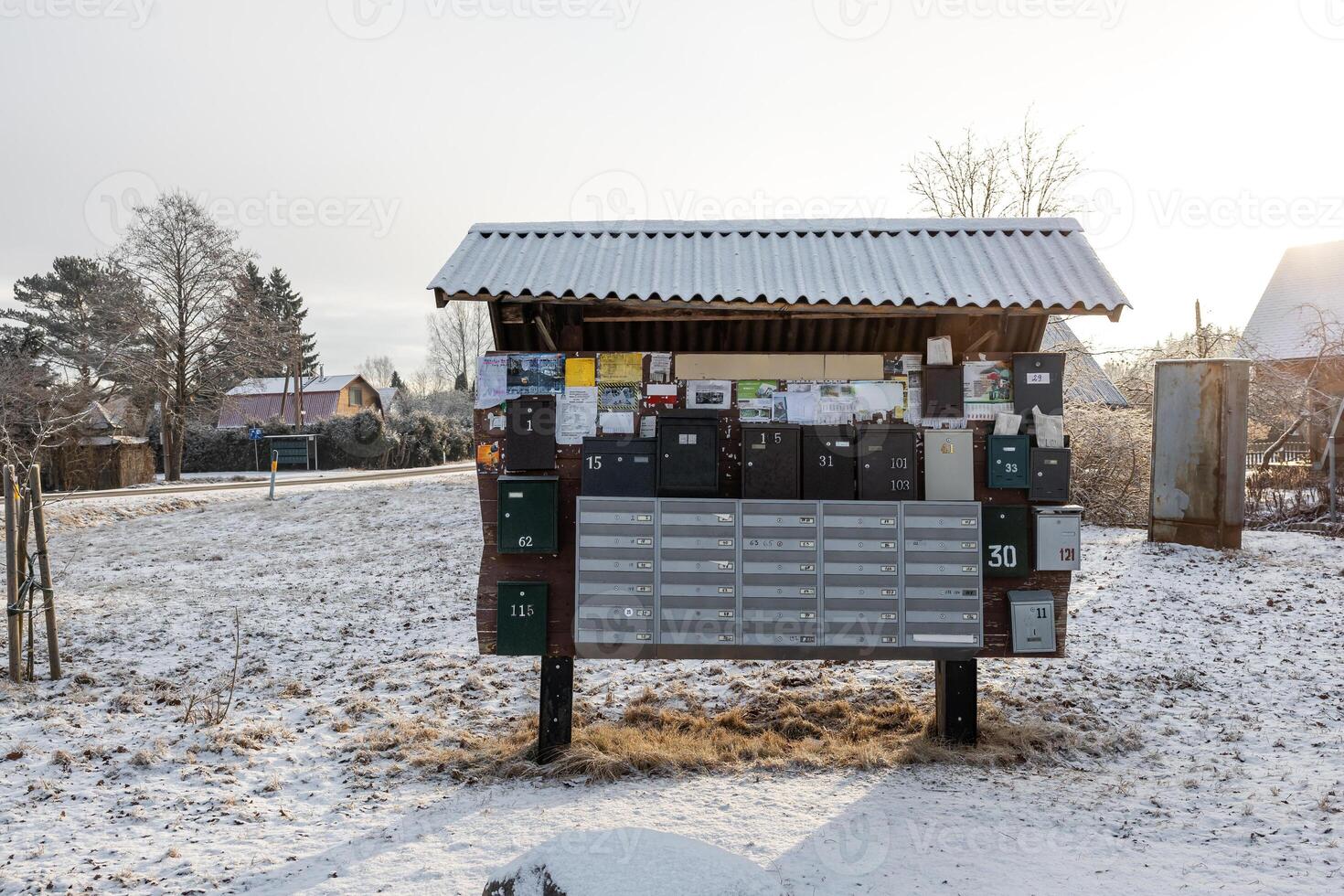 Snowy Outdoor Mailbox Structure with Corrugated Metal Roof photo