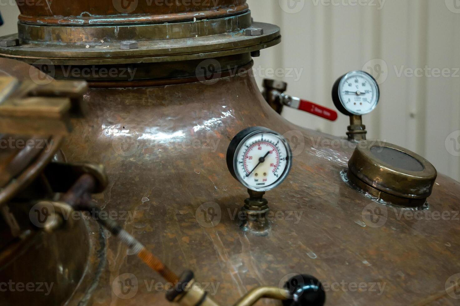 Close Up of Copper Still with Gauges and Valves in Distillery photo
