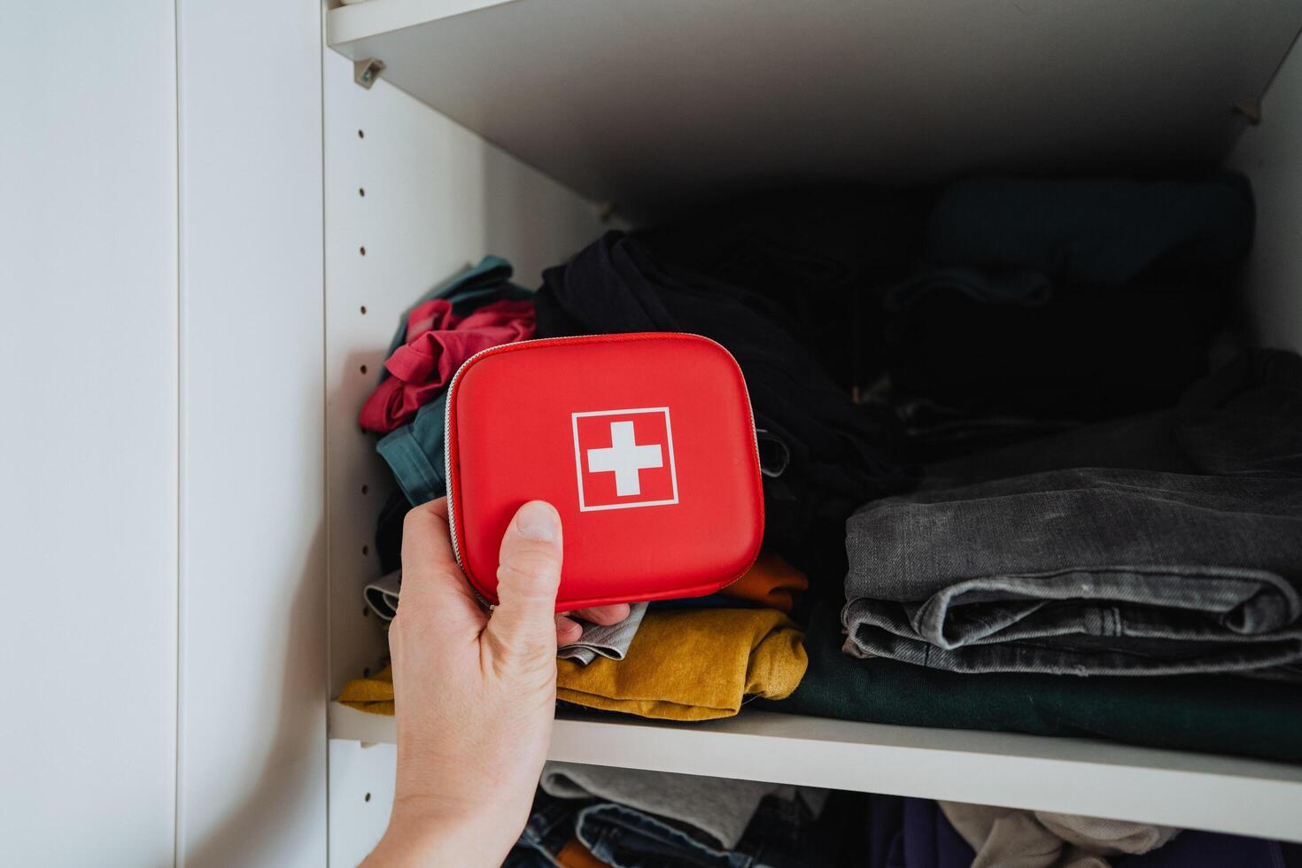An Essential First Aid Kit, perfectly prepared and fully stocked, is always ready for any unforeseen emergencies, conveniently placed on a neatly organized shelf for easy access photo