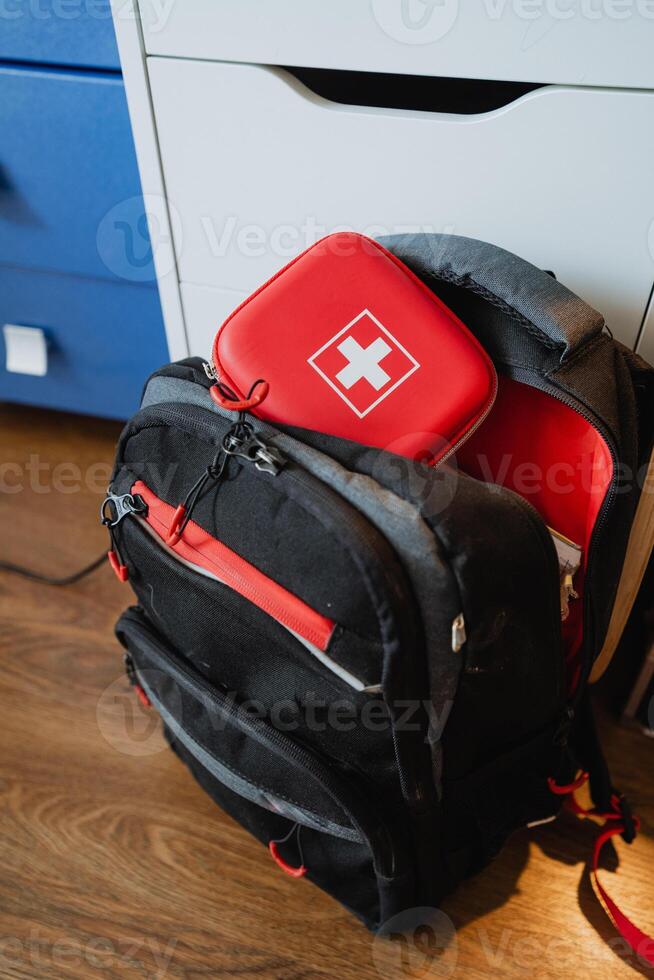 A sturdy and durable black backpack that includes a comprehensive first aid kit is absolutely essential for ensuring safety and preparedness during any outdoor adventure or trip photo