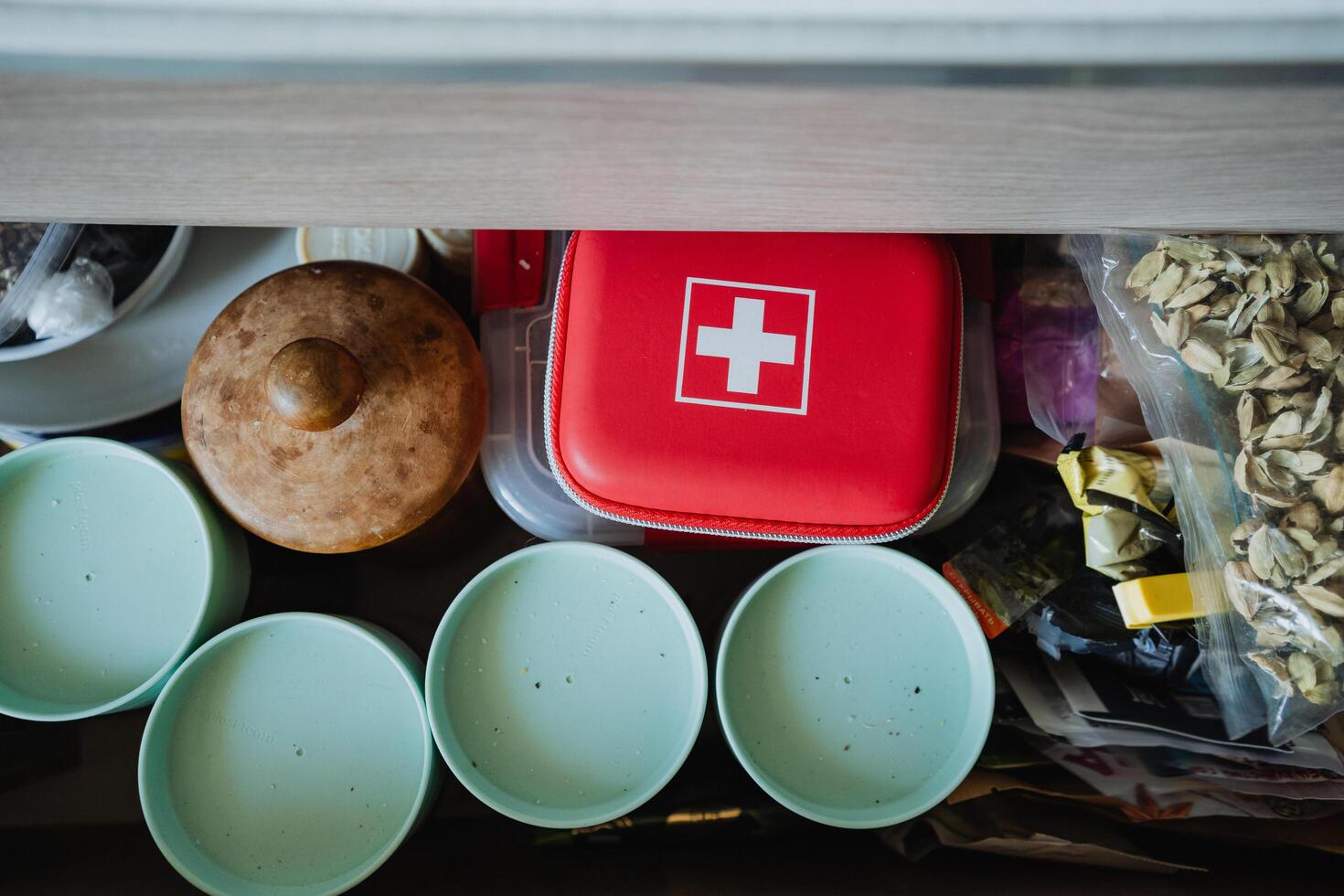 A wellorganized kitchen drawer is essential, holding a First Aid Kit, serving bowls, and snacks for quick access, ensuring convenience and efficiency in cooking photo