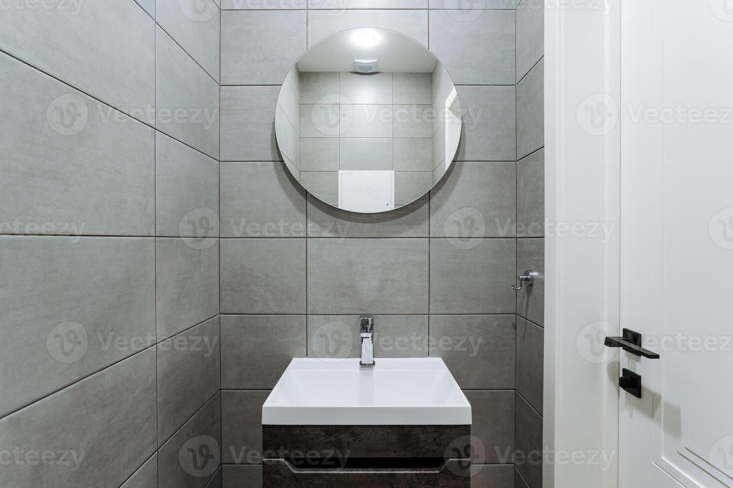 The bathroom features a beautifully designed sink along with a stylish mirror mounted on the wall, creating an aesthetically pleasing environment that enhances the overall space photo