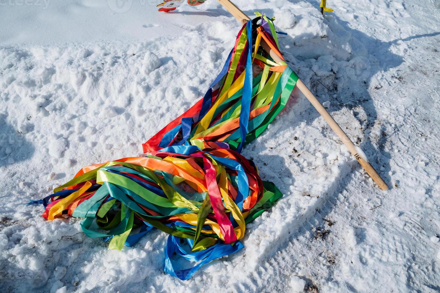 Colorful, vibrant ribbons are beautifully laid atop the pristine, untouched snow, creating a striking and captivating contrast against the pure white winter landscape all around photo
