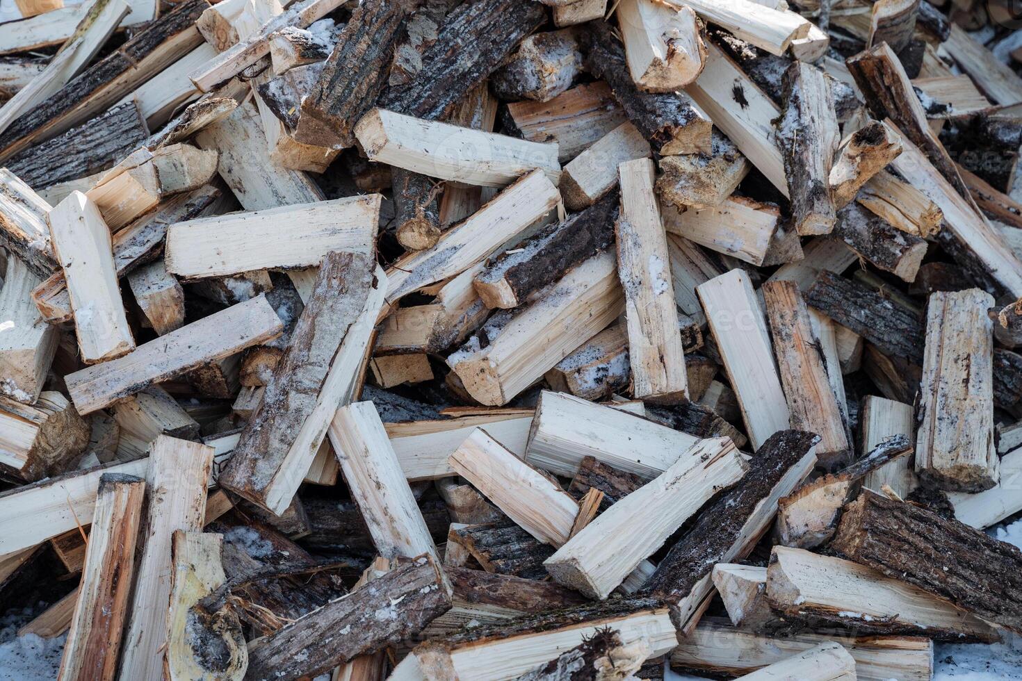A sizable pile of wood is situated right on top of an additional, similarly large pile of wood, creating a stacked effect that showcases the materials natural composition and structure photo
