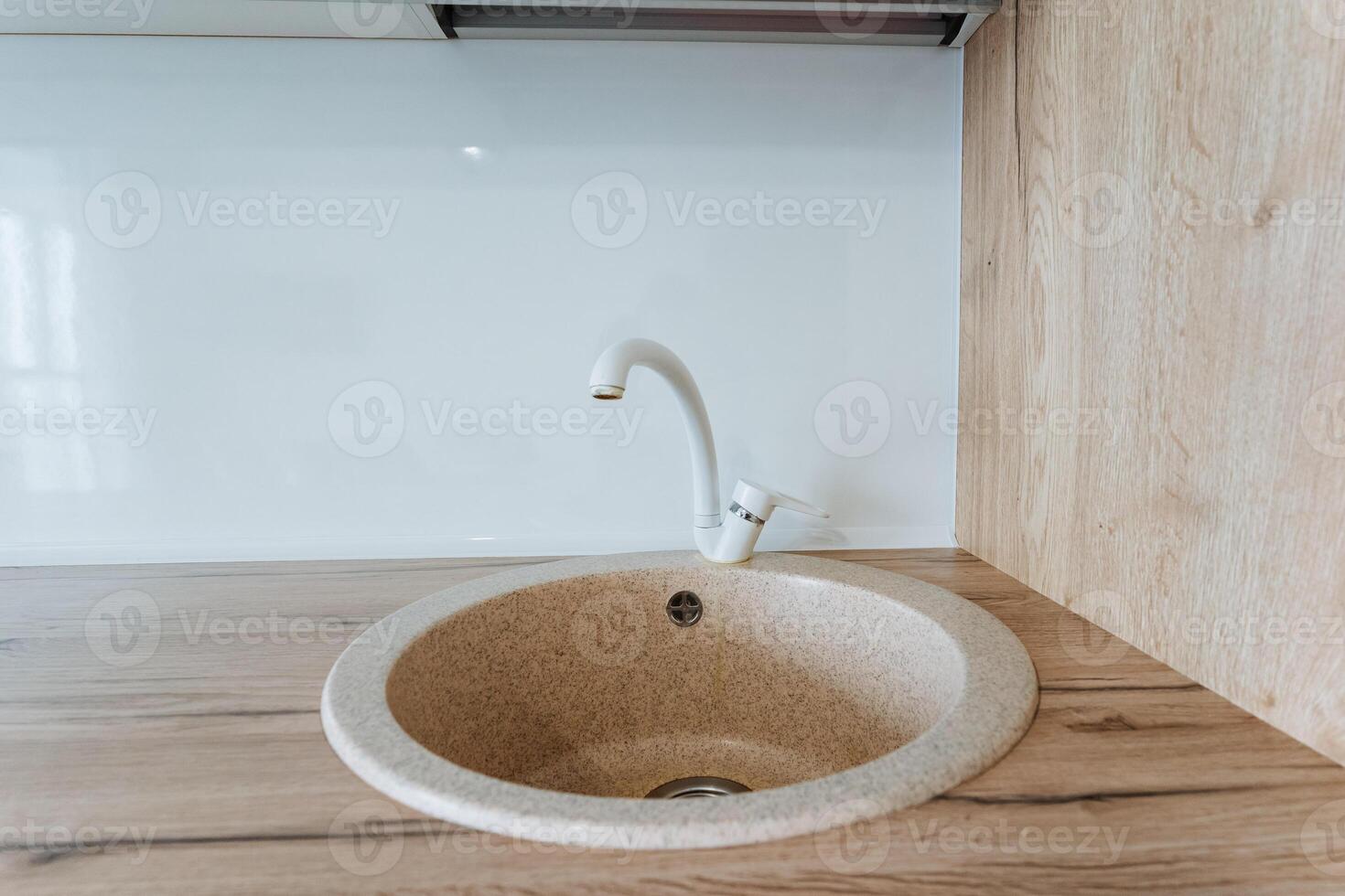 Discover a modern kitchen sink design with a sleek minimalist style and bright interior. Keywords cabinets, contemporary styles, stylish countertops, renovation ideas photo