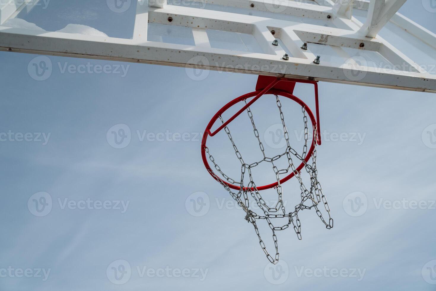 A vibrant basketball hoop against a clear blue sky symbolizes sport and recreation, inspiring joy, active engagement, and a sense of community among individuals photo