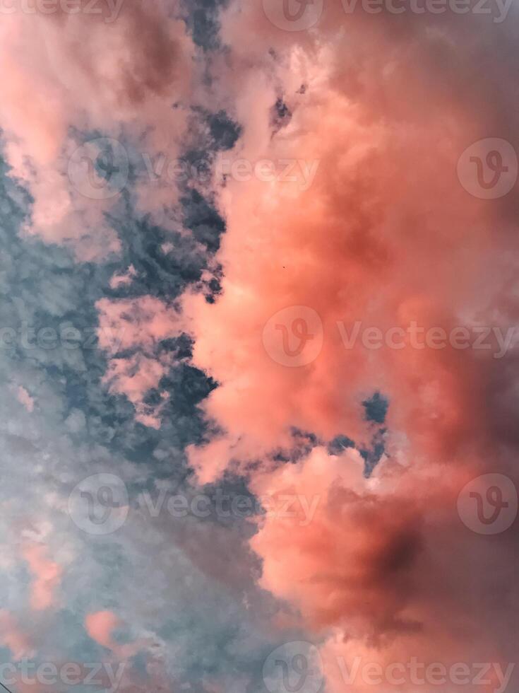 This image features a detailed closeup of a cloudy sky showcasing beautiful pink clouds against a backdrop that includes varying shades of blue, indicative of a bright daytime scene photo