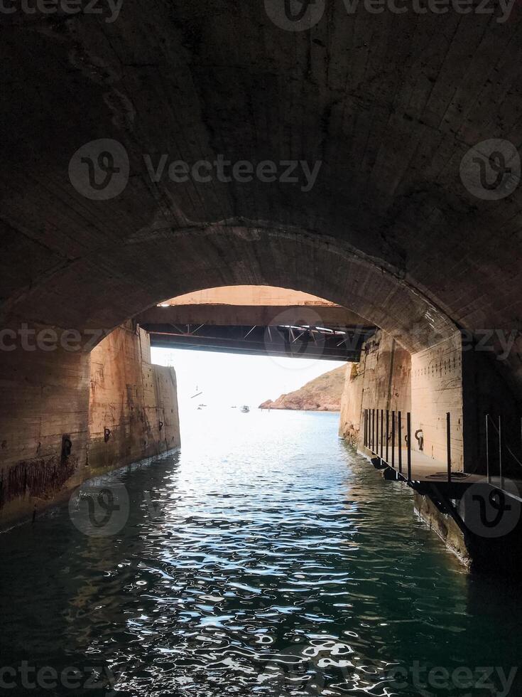 A fascinating and intriguing tunnel connects seamlessly to a vast and expansive body of water, creating a unique and remarkable link between the land and the surrounding aquatic environment photo