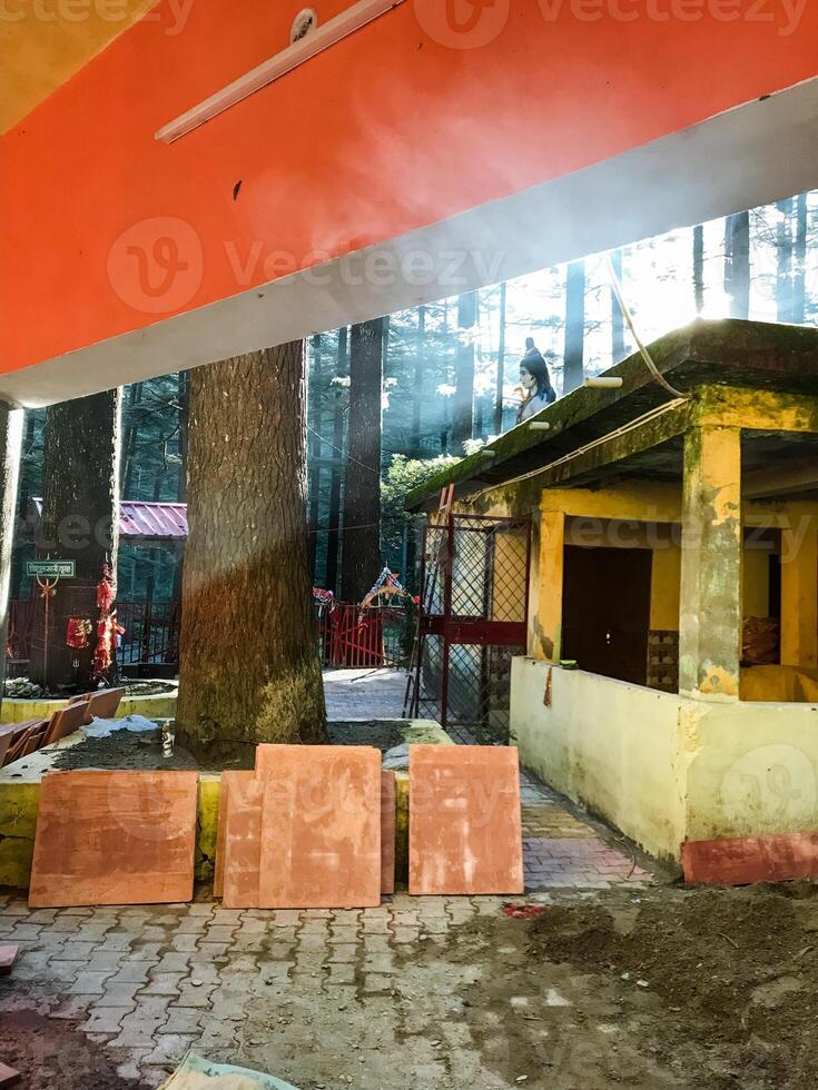 A distinctive building features a uniquely designed roof with vibrant orange and yellow colors, creating a striking visual appeal that attracts attention and leaves a lasting impression photo
