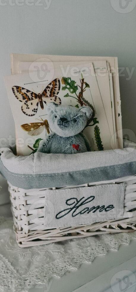 Vintage teddy bear toy sitting in basket photo