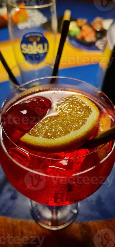 Red coctail with ice and lemon photo