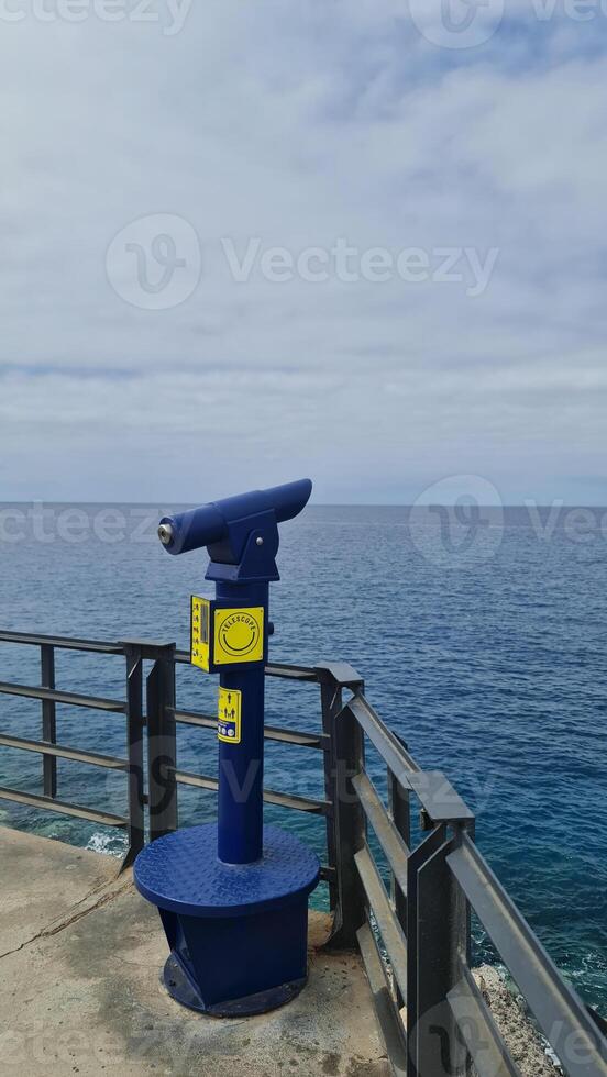 Blue viewing binoculars on the bridge photo