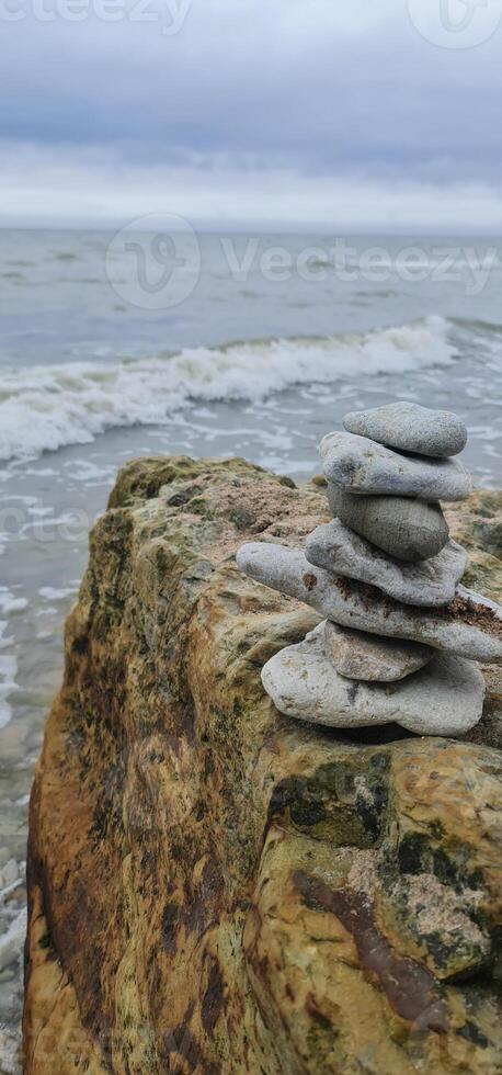 Cairn of the small stones on the beach photo