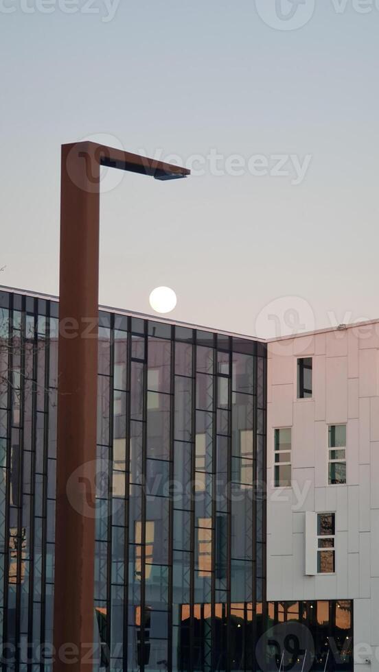 Street photography with moon on the sky photo