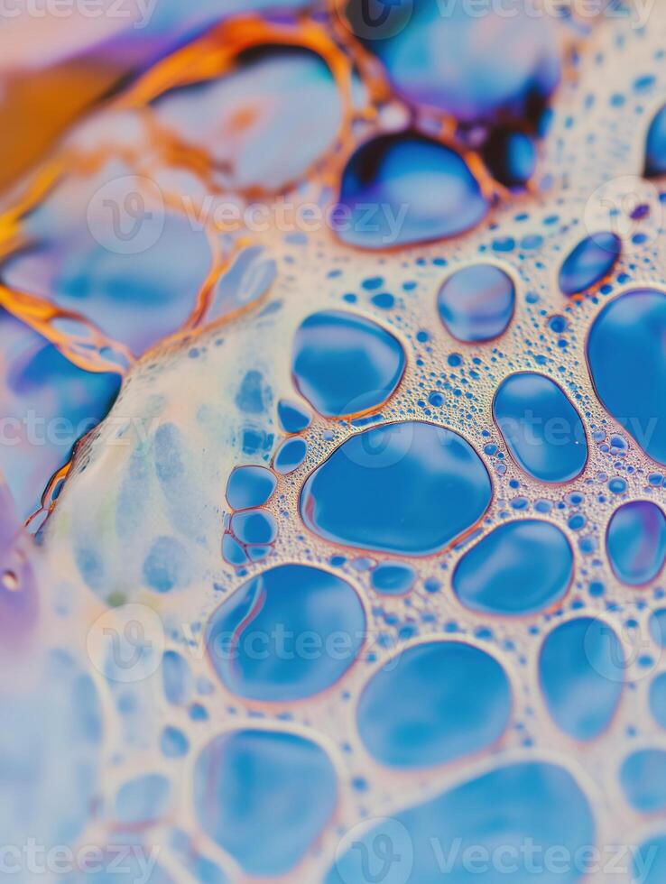 A close-up reveals a stunning tapestry of blue and gold bubbles creating an abstract pattern. photo