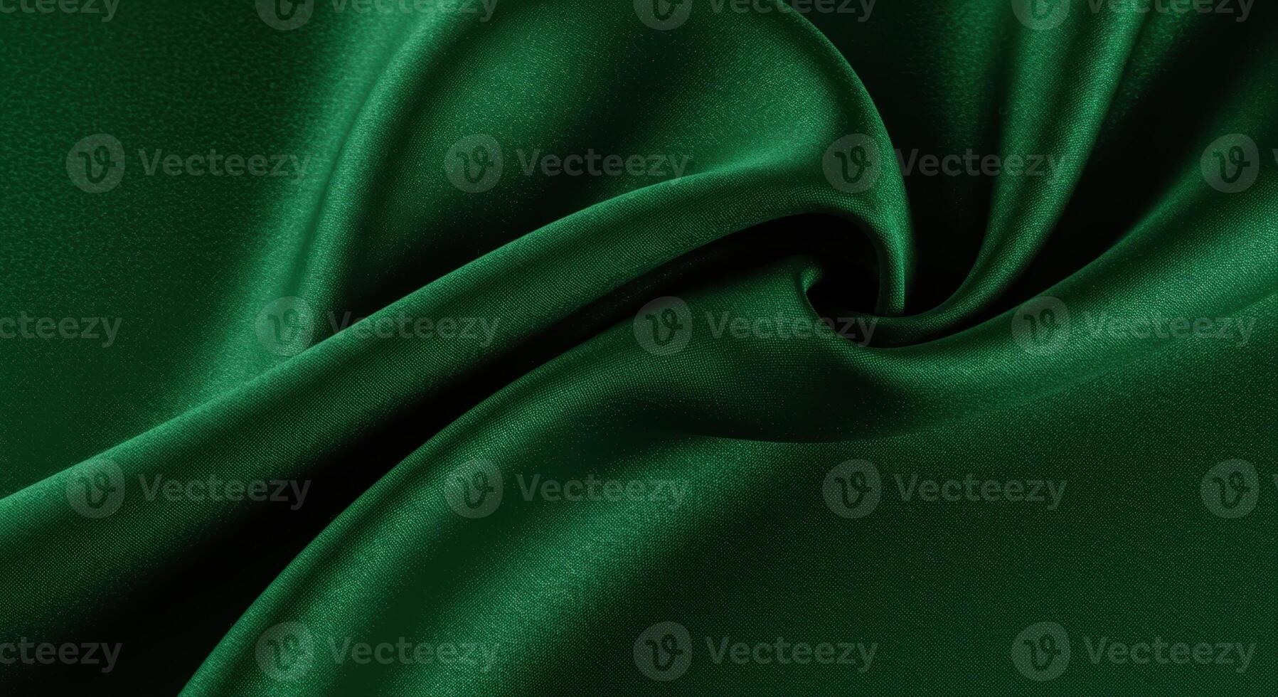 Lush emerald silk fabric drapes in elegant folds, creating a rich, smooth texture. photo