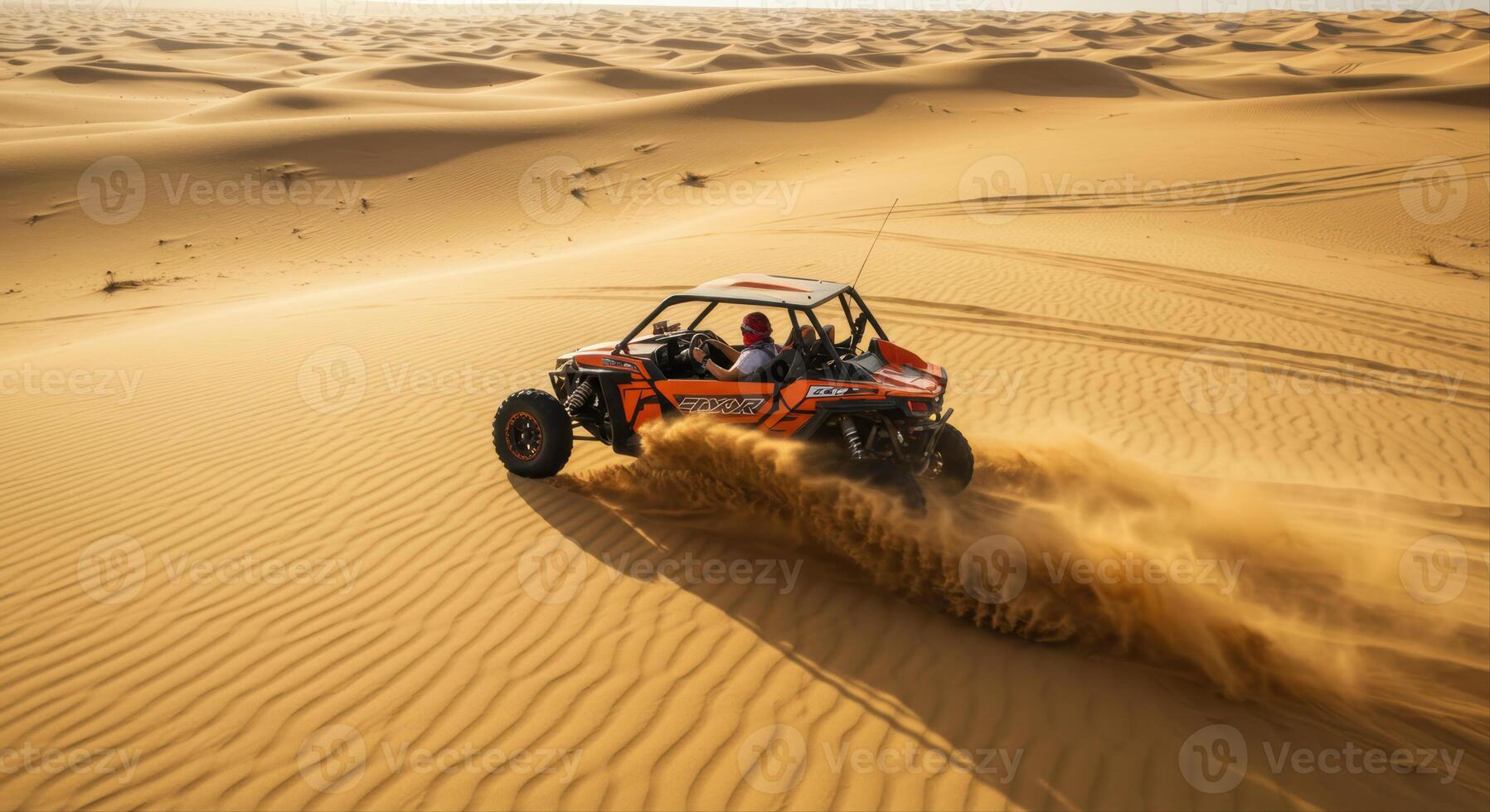 An orange dune buggy speeds across the undulating dunes of a vast desert landscape. photo