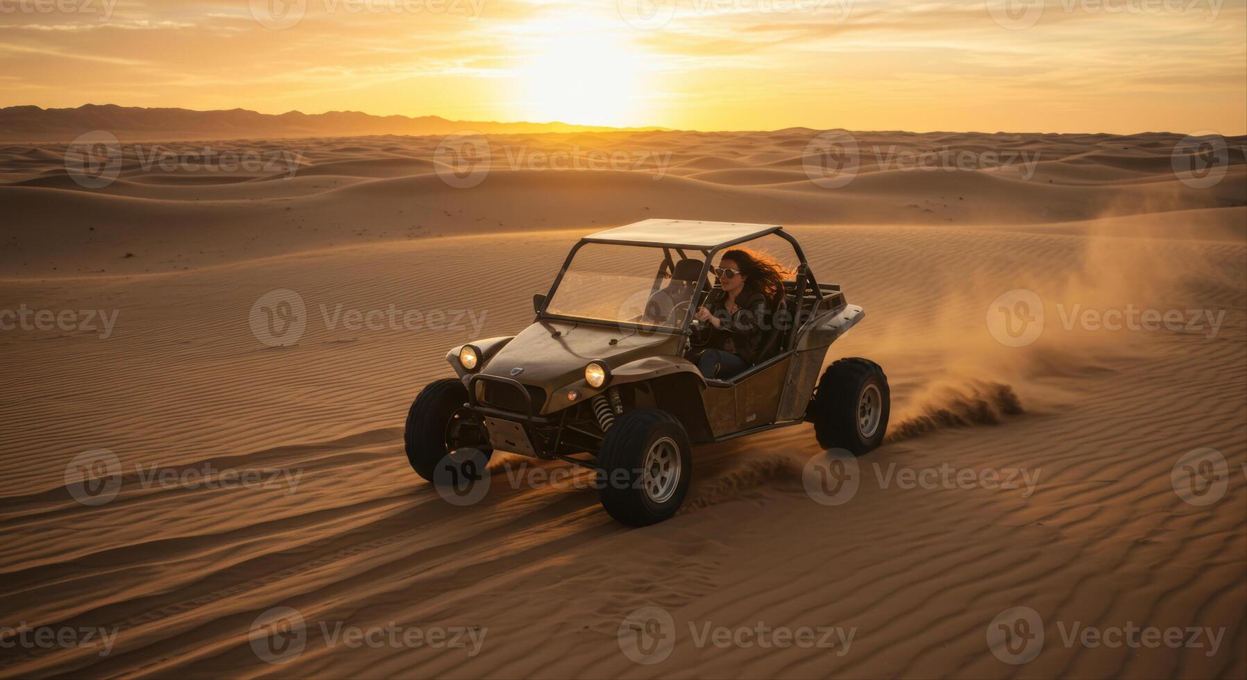 A woman speeds across the desert dunes in a buggy at sunset, enjoying the adventure. photo