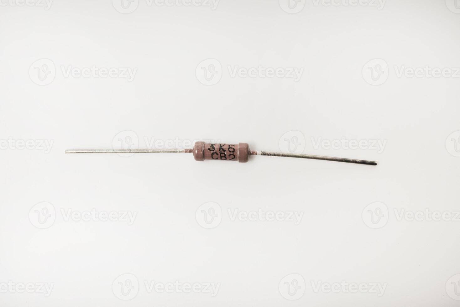 A brown resistor on a white background. The electronic component. photo