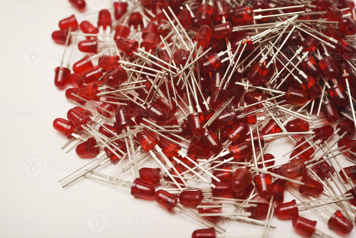 Ruby-hued LED diodes arranged against a stark white backdrop. The wireless module serves as an LED illumination device. photo