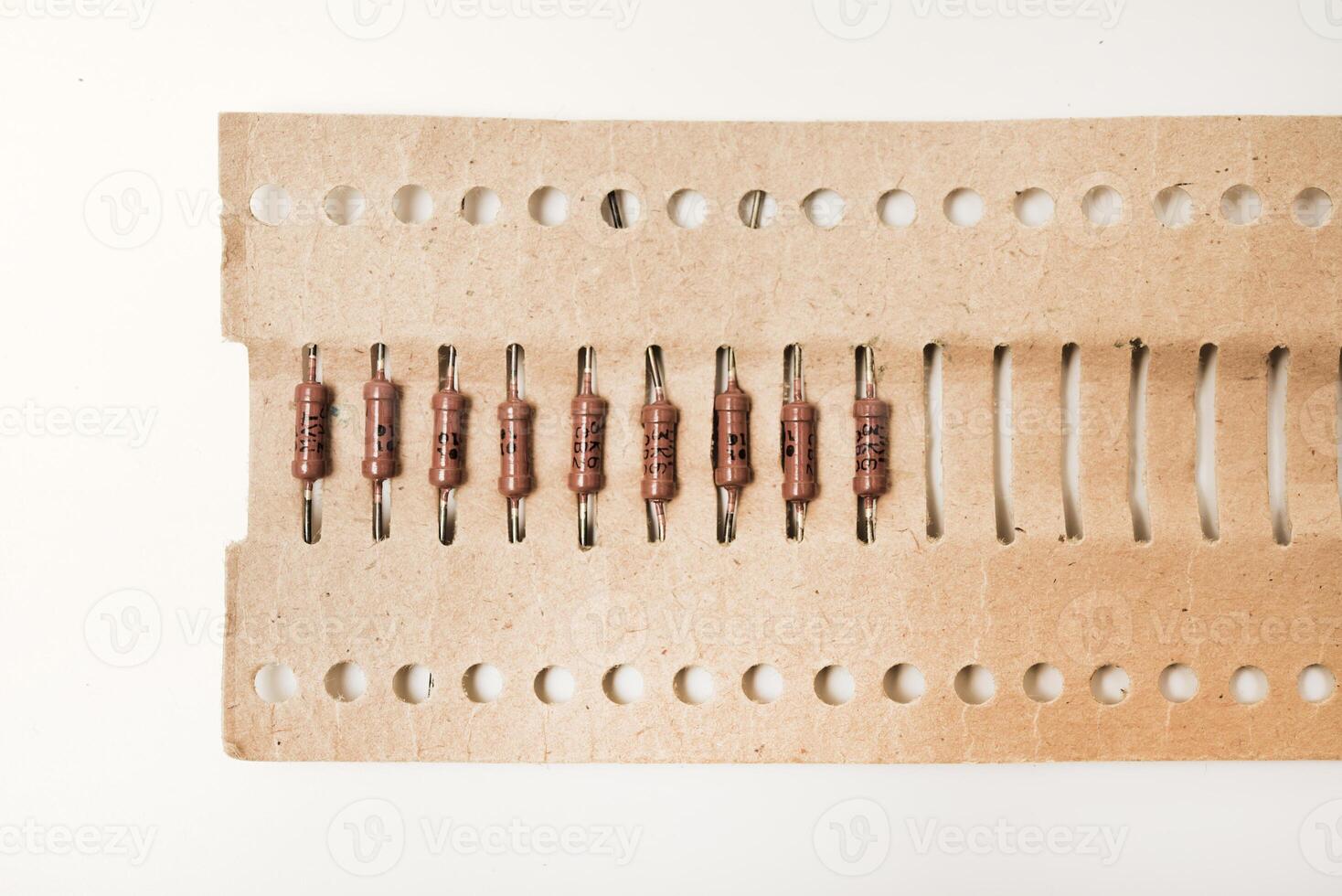 The electronic component. Brown resistor in a paper package. photo
