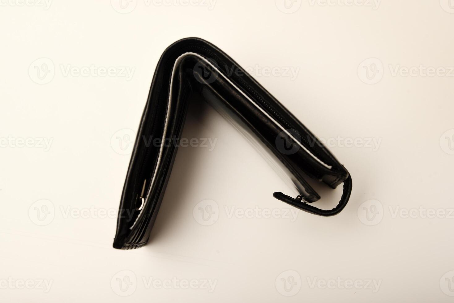 An obsidianhued money organizer with U.S. dollars on a white canvas. photo