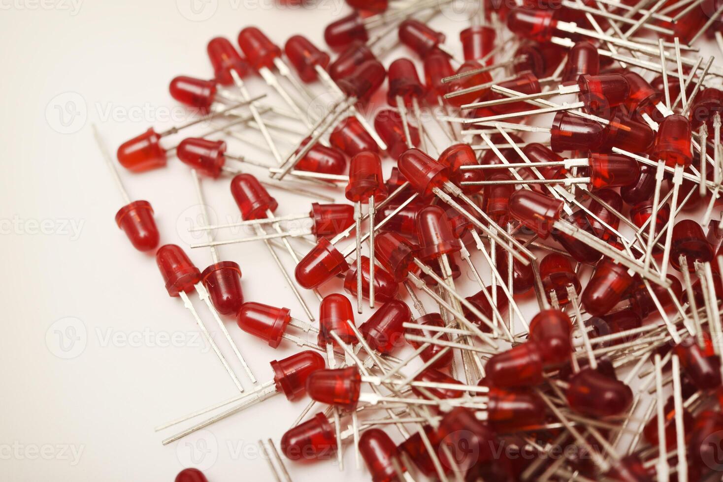 Scarlet LED lamps displayed on a clean white surface. The communication unit doubles as a light-emitting diode fixture. photo