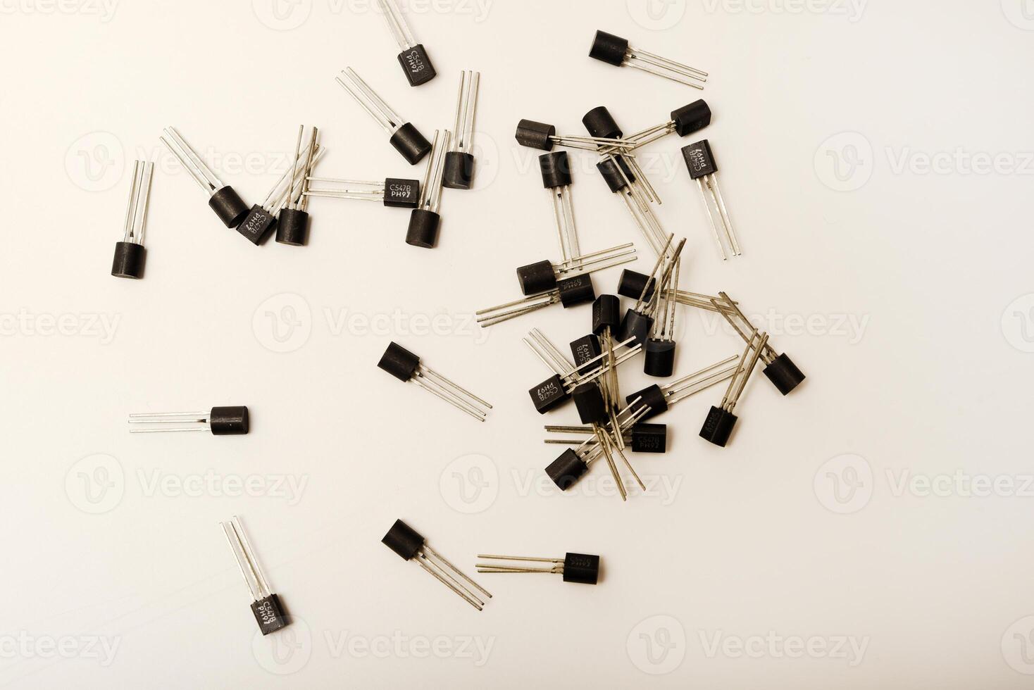 Dated transistors on a white base. Microchip elements. photo