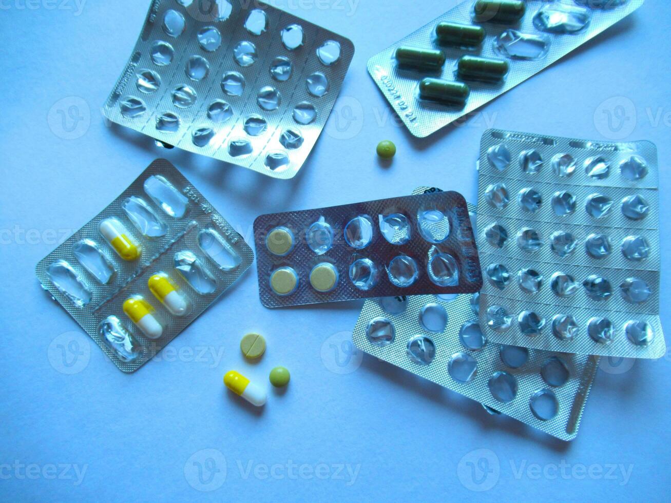 Empty pill blisters. A photo of medicines. Plates with leftover tablets