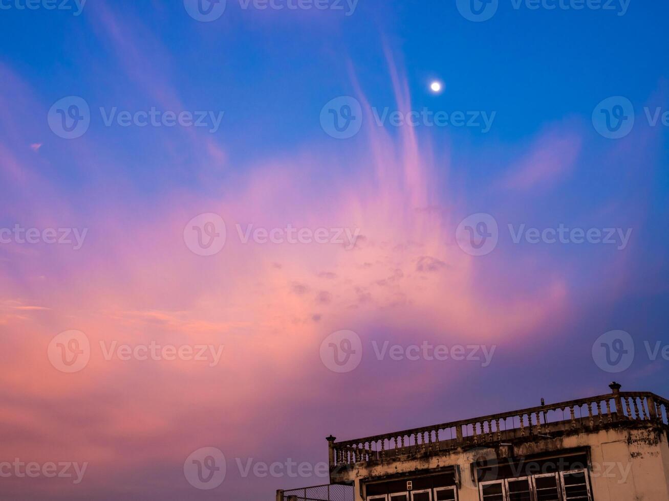 The Pink clouds and moon in sunset sky photo